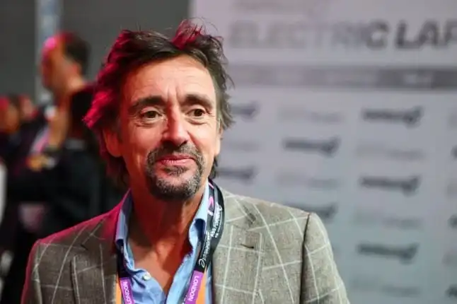 Richard Hammond pictured at a London motoring event — one of many public appearances that continue to add to his overall earnings. Few British broadcasters have built a career quite as varied — or as lucrative — as Richard Hammond. From reading local traffic reports on Yorkshire radio to co-hosting one of the most-watched car shows on the planet, Hammond's journey to wealth is a genuine rags-to-riches story. If you've been searching for accurate figures on Richard Hammond net worth, this guide breaks down exactly where his money comes from, how much he earned per episode, what his businesses are worth, and how he compares to his former Top Gear co-stars. As of 2026, Richard Hammond net worth is estimated at somewhere between £35 million and £37 million — roughly $45 million USD. That figure isn't a single confirmed number (celebrities rarely publish their bank statements), but it's the range most consistently reported across financial and entertainment outlets tracking his television deals, production company, and business ventures. Richard Hammond Net Worth 2026: Quick Facts Category Estimated Figure Richard Hammond net worth (2026) £35–37 million (~$45 million) Primary income source Television hosting (Top Gear / The Grand Tour) The Grand Tour Amazon Prime salary (peak) Up to £7.2 million/year Former Top Gear presenter earnings (BBC era) Around £500,000–£1 million/year Main business Chimp Productions, The Small Coggies restoration workshop Property Bollitree Castle, Herefordshire (~£7 million estate) Notable vehicles Porsche 911, Morgan Aeromax, Dodge Charger Marital status Divorced from Mindy Hammond (announced 2024/2025) Note: All net worth figures are informed estimates compiled from industry reporting, not officially confirmed by Hammond or his representatives. Who Is Richard Hammond? A Quick Background Born in Solihull, England, in December 1969, Richard Hammond started his broadcasting career far from the glitz of international television. He cut his teeth doing local radio shifts across Yorkshire — the kind of unglamorous, low-paying work that rarely leads anywhere. It wasn't until he landed a presenting role on the relaunched BBC motoring show Top Gear in 2002 that his career, and by extension his bank balance, began to change dramatically. Alongside Jeremy Clarkson and James May, Hammond helped turn Top Gear into a global entertainment phenomenon broadcast in dozens of countries. That trio would go on to leave the BBC together in 2015 and relaunch under a new banner — a move that would ultimately supercharge Richard Hammond net worth far beyond what BBC salaries alone could have delivered. How Rich Is Richard Hammond? Breaking Down the Numbers So, how rich is Richard Hammond exactly? The honest answer is that nobody outside his accountant knows the precise figure. What we do know is that his income has come from several overlapping streams rather than one single paycheck, which is typical for veteran television presenters who diversify into production, publishing, and entrepreneurship. Richard Hammond Salary and Income Sources Hammond's overall earnings break down roughly into these categories: Television hosting fees — by far the largest contributor to his wealth Book deals and publishing — including his memoir On the Edge: My Story Production company revenue — through Chimp Productions Business ownership — including his classic car restoration workshop Digital media ventures — such as his co-founding stake in DriveTribe Endorsements and sponsorships — tied to his motoring and lifestyle brand Combined, these streams make up Richard Hammond overall earnings, which is why his fortune has continued to grow even after stepping back from full-time weekly television. The Grand Tour Amazon Prime Salary When Hammond, Clarkson, and May left the BBC in 2015, Amazon Prime Video swooped in with a reported nine-figure deal to bring the trio's chemistry to its streaming platform under the new banner, The Grand Tour. Reports from the launch year put individual salaries at around $7 million annually, with some estimates suggesting Hammond's earnings climbed as high as £7.2 million per year at peak contract levels. This single move is widely credited as the turning point that took Richard Hammond net worth from comfortable to genuinely wealthy. Former Top Gear Presenter Earnings (BBC TV Host Contract) Before the Amazon jump, Hammond's BBC TV host contract was considerably more modest by comparison — reportedly somewhere in the £500,000 to £1 million per year range during the height of Top Gear's popularity between 2002 and 2015. While that's still a substantial salary by most standards, it pales next to what streaming money would later deliver, illustrating just how much the industry shifted once tech companies began competing for premium talent. Richard Hammond's Business Ventures Television pay built the foundation, but it's Hammond's business ventures that have helped sustain and diversify his wealth beyond his presenting years. DriveTribe: Digital Media Co-Founder In 2016, Hammond co-founded DriveTribe, a digital media and social platform aimed at car enthusiasts, alongside Clarkson and May. While the platform has evolved significantly since launch, it represented an early and savvy move into digital content ownership at a time when many broadcasters were still entirely reliant on traditional TV deals. Chimp Productions Chimp Productions is Hammond's own production company, through which he has developed and produced several of his more recent projects. Owning a production company rather than simply appearing as talent-for-hire gives Hammond a stake in the intellectual property and long-term revenue of his shows, rather than a one-off appearance fee. The Small Coggies Classic Car Restoration Business Hammond's genuine passion for cars extends into ownership, most notably through his classic car restoration workshop, often referred to in coverage as The Small Coggies (also styled The Smallest Cog). This Herefordshire-based business restores and sells classic vehicles, blending his personal interests with a commercially viable enterprise. Richard Hammond's Workshop (Discovery+) The restoration business also became the subject of its own television series, Richard Hammond's Workshop, streaming on Discovery+. The show follows Hammond and his small team as they rebuild classic and unusual vehicles, giving the business added exposure while generating additional production income. Real Estate: Bollitree Castle, Herefordshire One of the most talked-about assets tied to Richard Hammond net worth is his home, Bollitree Castle, a Herefordshire estate he purchased in 2008 for around £2 million. Following renovation and years of rising UK property values, the estate — which also houses his restoration workshop — has been valued in more recent estimates at approximately £7 million. This single property represents a meaningful slice of his overall net worth and doubles as the working home for his car restoration business. Richard Hammond's Luxury Supercar Collection As you'd expect from a lifelong motoring presenter, Hammond's personal garage is famously eclectic. Vehicles associated with his collection over the years include: Porsche 911 — a staple sports car in his rotation Morgan Aeromax — a rare, hand-built British grand tourer Dodge Charger — reflecting his appreciation for American muscle Robinson R44 helicopter — used for personal travel and filming purposes His collection has evolved considerably over the years, partly shaped by his well-documented high-speed crashes, including the 2006 jet dragster incident and the 2017 Rimac crash while filming The Grand Tour, both of which briefly interrupted his presenting career but didn't derail it long-term. Top Gear Trio Net Worth Comparison Comparing the wealth of the three former Top Gear hosts is a favorite pastime among motoring fans, and it's a useful way to put Richard Hammond net worth into context. Presenter Estimated Net Worth (2026) Jeremy Clarkson ~£50–60 million Richard Hammond ~£35–37 million James May ~£20–25 million Jeremy Clarkson vs Richard Hammond Net Worth When comparing Jeremy Clarkson vs Richard Hammond net worth, Clarkson typically comes out ahead, largely thanks to his additional ventures — most notably his farming brand and Clarkson's Farm on Amazon Prime, alongside his long-running newspaper columns and earlier Top Gear-era production credits. James May Net Worth James May net worth is generally reported as the most modest of the three, though still substantial by any normal standard. May has leaned more into books, food and drink content (including his gin brand), and niche broadcasting projects rather than the larger commercial ventures pursued by his former co-hosts. Mindy Hammond Divorce Settlement Hammond's personal finances came under renewed scrutiny following news of his split from wife Mindy Hammond, reported publicly around late 2024 into early 2025, after more than two decades of marriage. As with most high-net-worth UK divorces, the Mindy Hammond divorce settlement terms have not been made public, and any financial impact on Hammond's overall fortune remains speculative. Divorce settlements involving jointly held property — such as the Herefordshire estate — can meaningfully affect reported net worth figures, which is one reason estimates for Richard Hammond net worth 2026 vary fairly widely between sources. How Richard Hammond Built His Multi-Million Dollar TV Career Understanding how Hammond accumulated his wealth offers a genuinely instructive case study for anyone interested in media careers: Start small and build credibility — years of unglamorous local radio work in Yorkshire gave him broadcasting fundamentals before fame arrived. Land a breakout role — joining the relaunched Top Gear in 2002 put him in front of a global audience. Negotiate collectively — leaving the BBC as a trio with Clarkson and May gave all three significantly more leverage with Amazon. Diversify beyond presenting — founding Chimp Productions and co-founding DriveTribe meant Hammond began earning from ownership, not just appearance fees. Monetize genuine passions — turning his personal love of classic cars into an actual restoration business and TV series. Invest in appreciating assets — property like Bollitree Castle has grown substantially in value since purchase. For a deeper look at how UK television talent salaries have shifted in the streaming era, the <a href="https://www.bbc.co.uk" target="_blank" rel="noopener">BBC</a> has published extensive coverage on the broader shift of major presenters from traditional broadcast deals to streaming platforms. What Business Does Richard Hammond Own? If you're specifically searching for what business does Richard Hammond own, the short answer is: several. His primary ventures include Chimp Productions (his TV production company), his classic car restoration workshop in Herefordshire, and his earlier co-founding role in DriveTribe. He has also been listed as a director across multiple UK companies over the years, though a complete public list isn't available. How Much Is Richard Hammond's Car Collection Worth? While no official valuation has been published, estimates for how much is Richard Hammond car collection worth typically range into the hundreds of thousands of pounds when accounting for his supercars, classic restorations, and the Robinson R44 helicopter, though the true figure fluctuates constantly given how frequently vehicles move in and out of his garage through the restoration business. Frequently Asked Questions 1. How much is Richard Hammond's net worth in 2026? Most estimates place Richard Hammond net worth 2026 at approximately £35–37 million, or around $45 million USD, though figures from different outlets range as widely as $30–60 million. 2. How much did Richard Hammond make per episode of The Grand Tour? Exact per-episode figures aren't published, but reports on his annual Amazon contract suggest earnings of up to £7.2 million per year at peak, implying a very substantial per-episode rate once averaged across a season. 3. Was Richard Hammond paid more at the BBC or Amazon? Amazon paid dramatically more. His BBC-era salary was reportedly in the £500,000–£1 million range annually, while his Grand Tour deal reportedly pushed well into seven figures per year. 4. What was Brainiac: Science Abuse and did it add to his wealth? Yes — before Top Gear made him a household name globally, Hammond also hosted Brainiac: Science Abuse, an earlier presenting credit that added to his broadcasting résumé and income during that period. 5. Did Richard Hammond present Total Wipeout? Yes, Hammond was the Total Wipeout presenter, an obstacle-course entertainment show that ran alongside his motoring work and added another income stream outside the Top Gear/Grand Tour franchise. 6. Is Richard Hammond richer than Jeremy Clarkson? No — when comparing Jeremy Clarkson vs Richard Hammond net worth, Clarkson is generally estimated to be wealthier, largely due to his farming brand and additional media projects. 7. How did the Mindy Hammond divorce affect his net worth? The settlement terms are private, so the precise financial impact is unknown, though property division is typically a factor in high-net-worth UK divorces of this kind. Final Thoughts Richard Hammond net worth tells the story of a broadcaster who turned a modest start in local radio into one of the most recognizable and financially successful motoring media careers in the world. Between his television salary history, his production company, his classic car restoration business, and a Herefordshire estate now worth millions, Hammond's fortune reflects decades of steady, diversified career-building rather than a single lucky break. While exact figures remain estimates, the consensus places him comfortably among the wealthiest British television presenters working today.